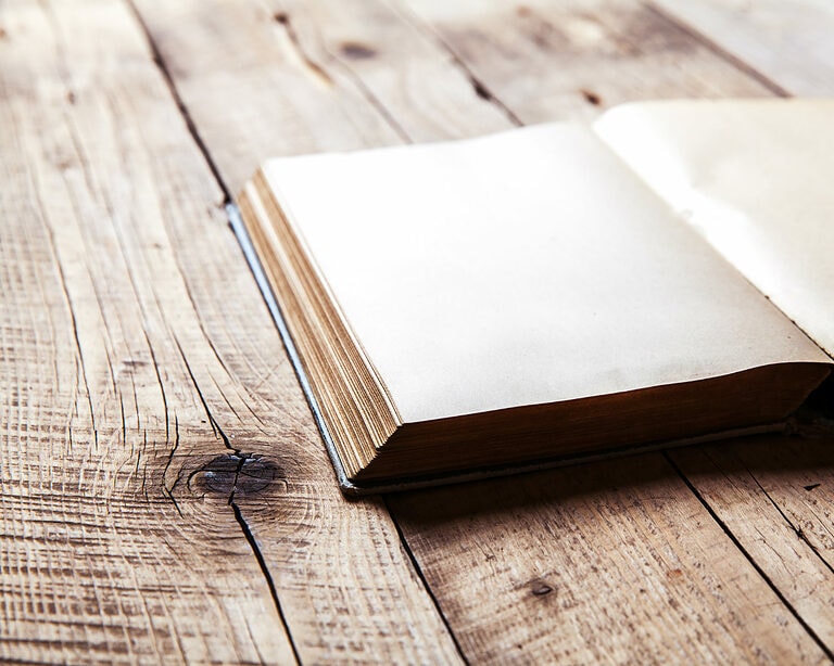 book open on old wooden table